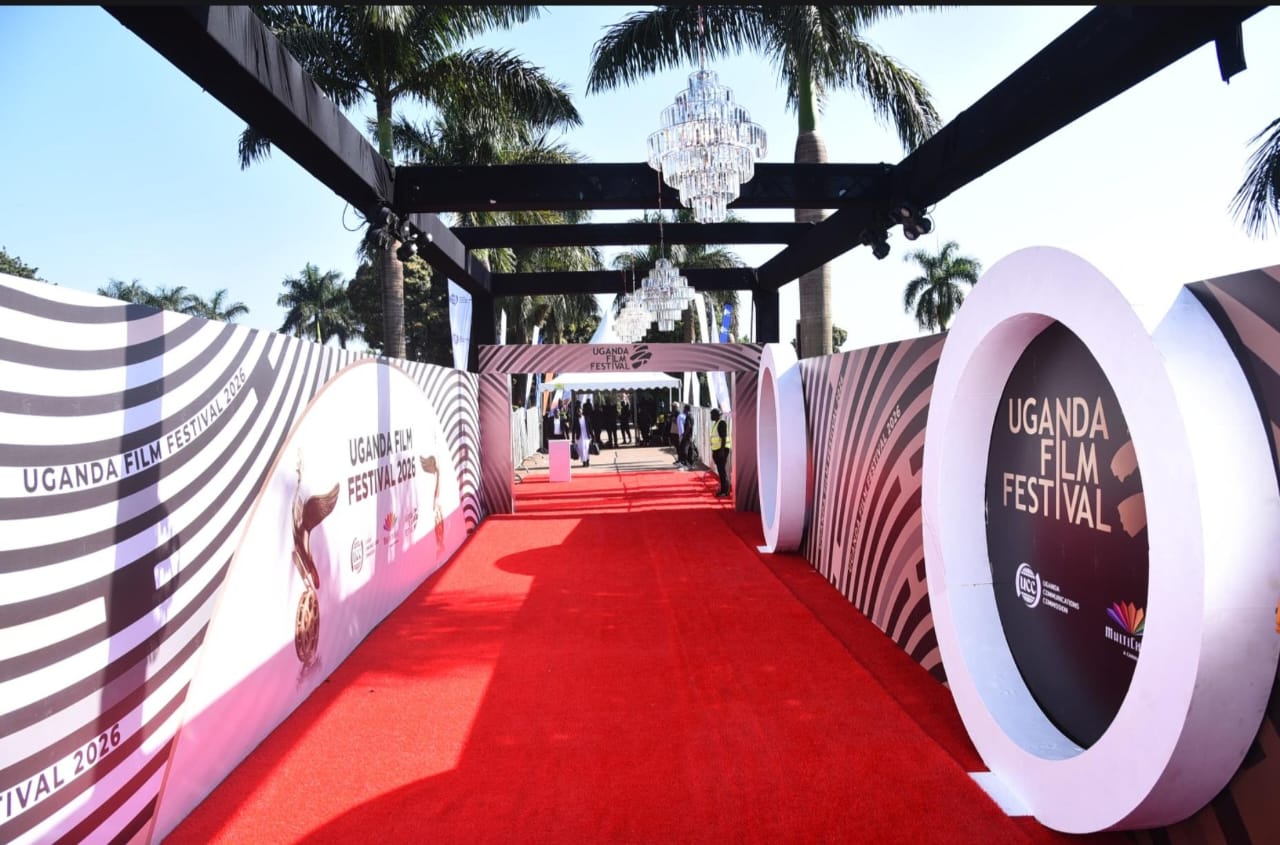 Branded red carpet arrival corridor with festival signage and chandeliers