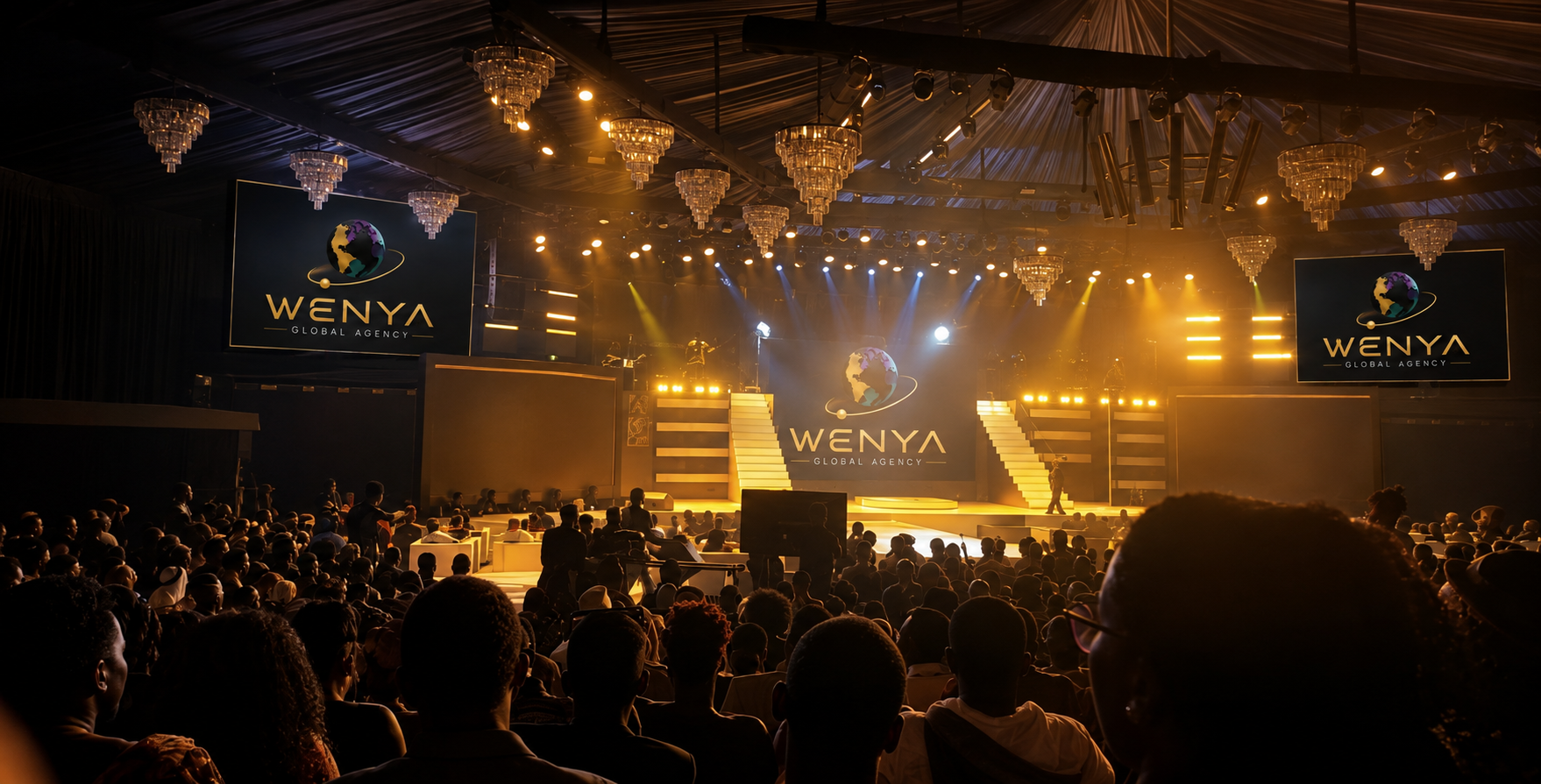Large awards ceremony with Wenya Global Agency branding on stage screens and a full audience
