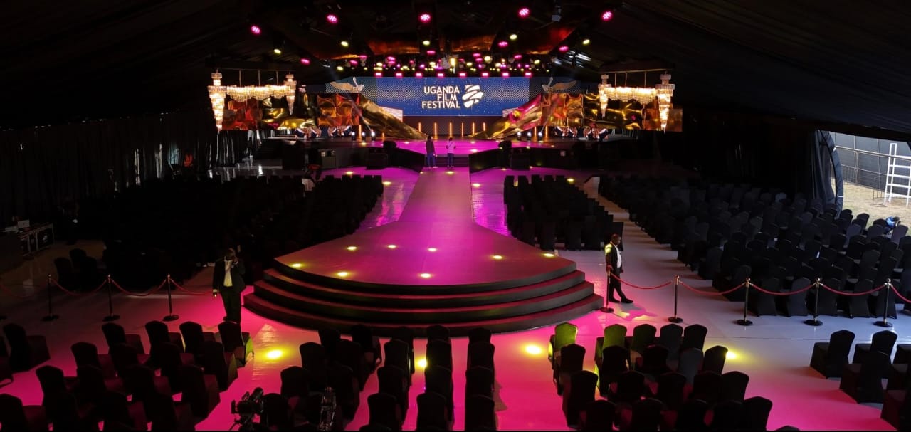 Awards gala hall lit in pink with a raised runway stage and rows of seating at Nasser Theatre
